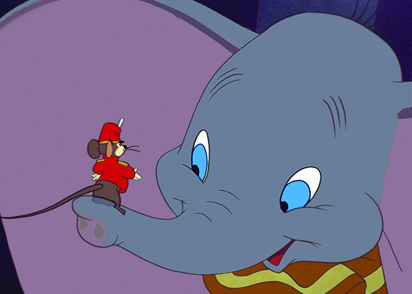 A cartoon of an elephant with a dressed up mouse on it's trunk.