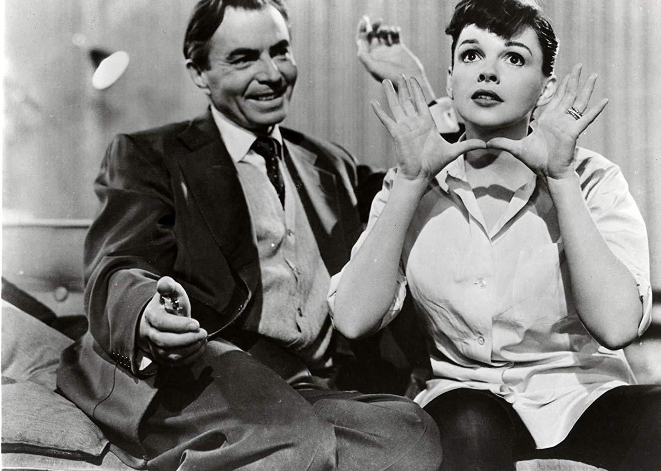Judy Garland and a man sitting together.