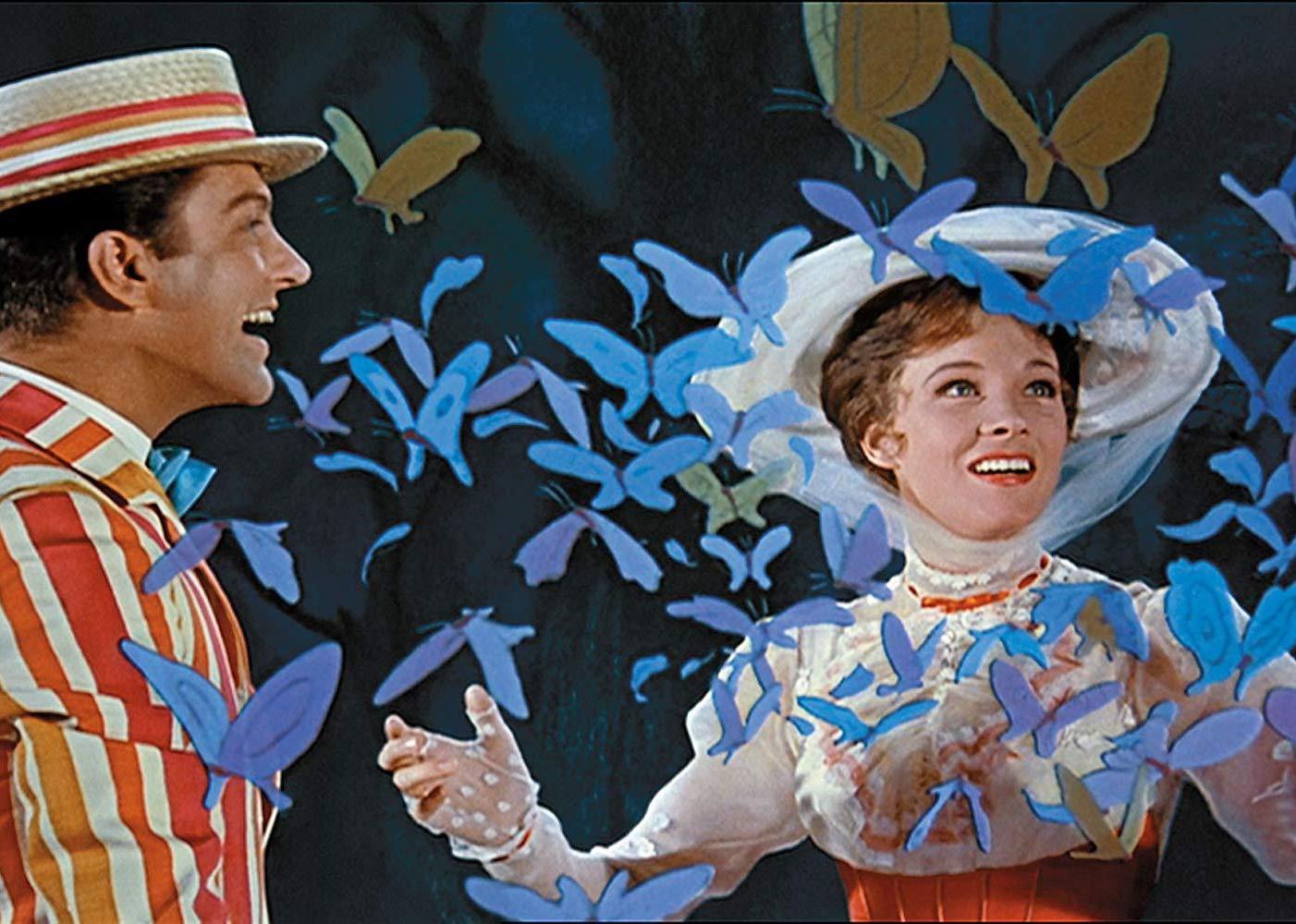 Julie Andrews and Dick Van Dyke laughing while cartoon butterflies surround them.