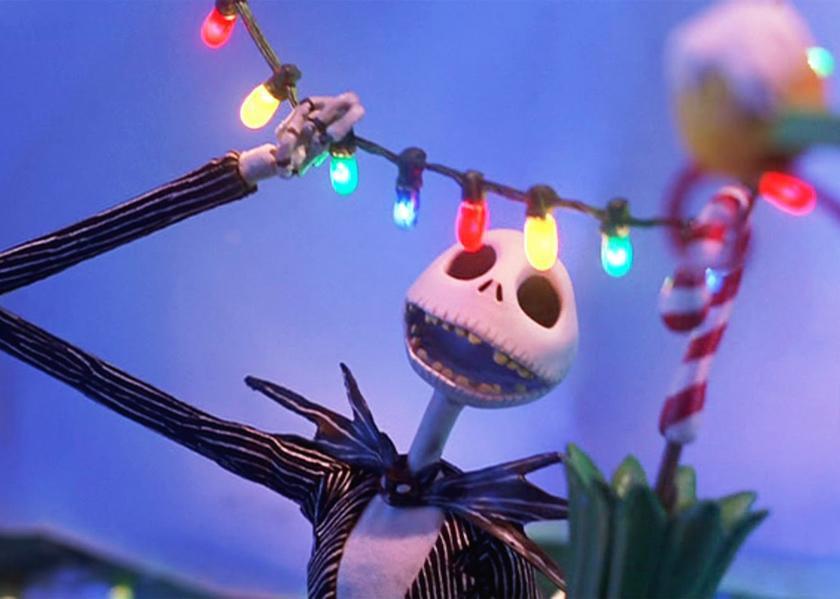 An animated skeleton in a pinstripe suit singing  and hanging christmas lights.