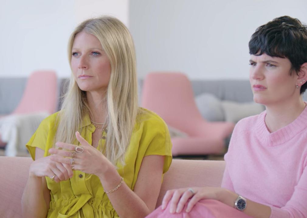Gwyneth Paltrow and one of her co-workers sit on an interview couch.