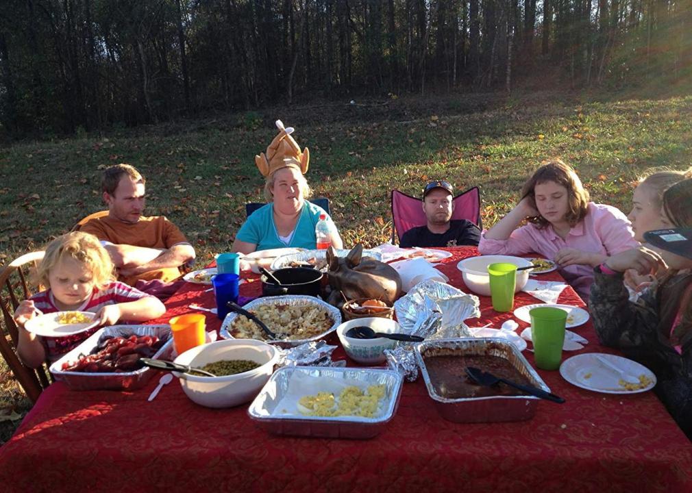 Honey Boo Boo and her family eating at a table outside.
