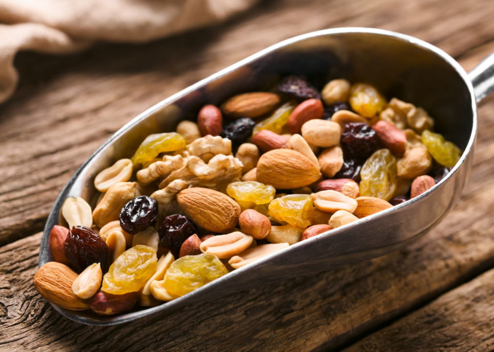 Dried fruit and nut mix in a metal scoop.