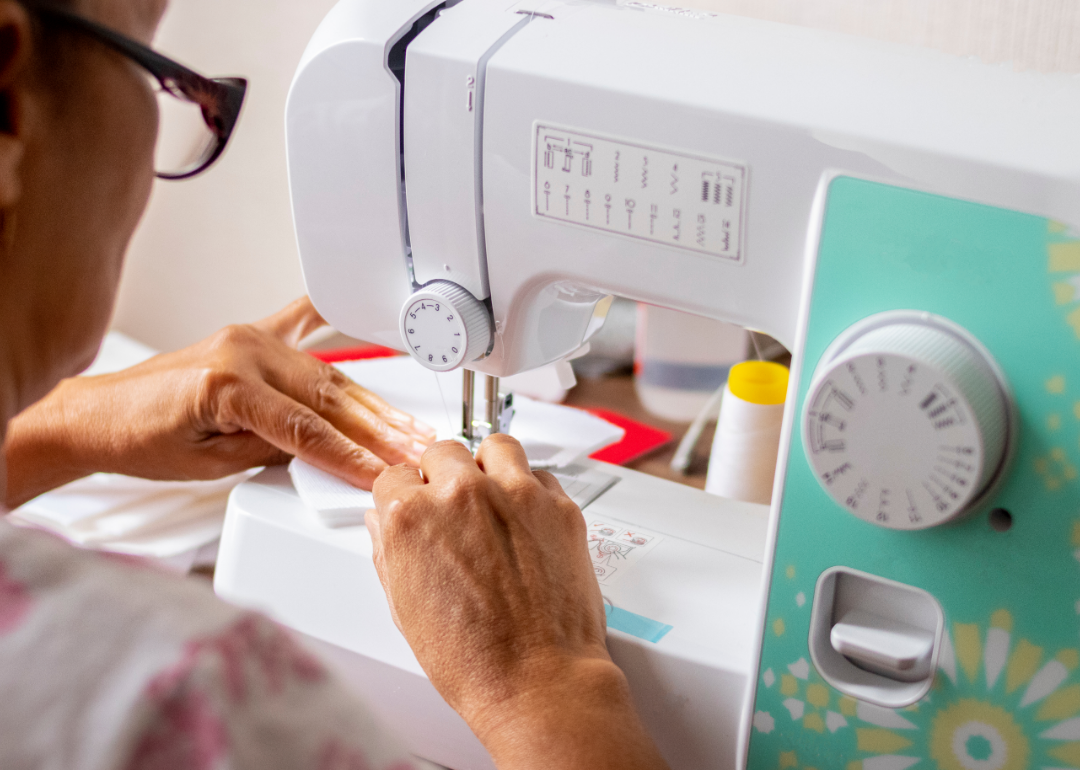 A sewing machine worker sews a piece of clothing