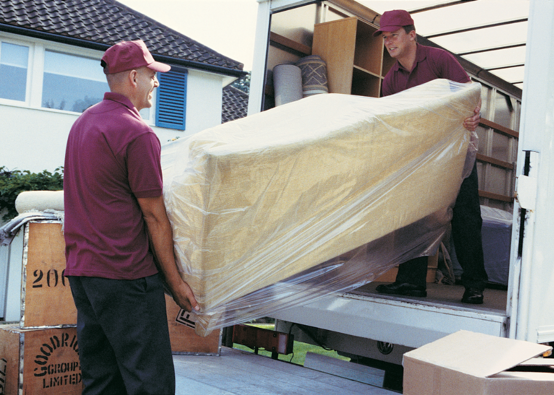 Movers unload a couch