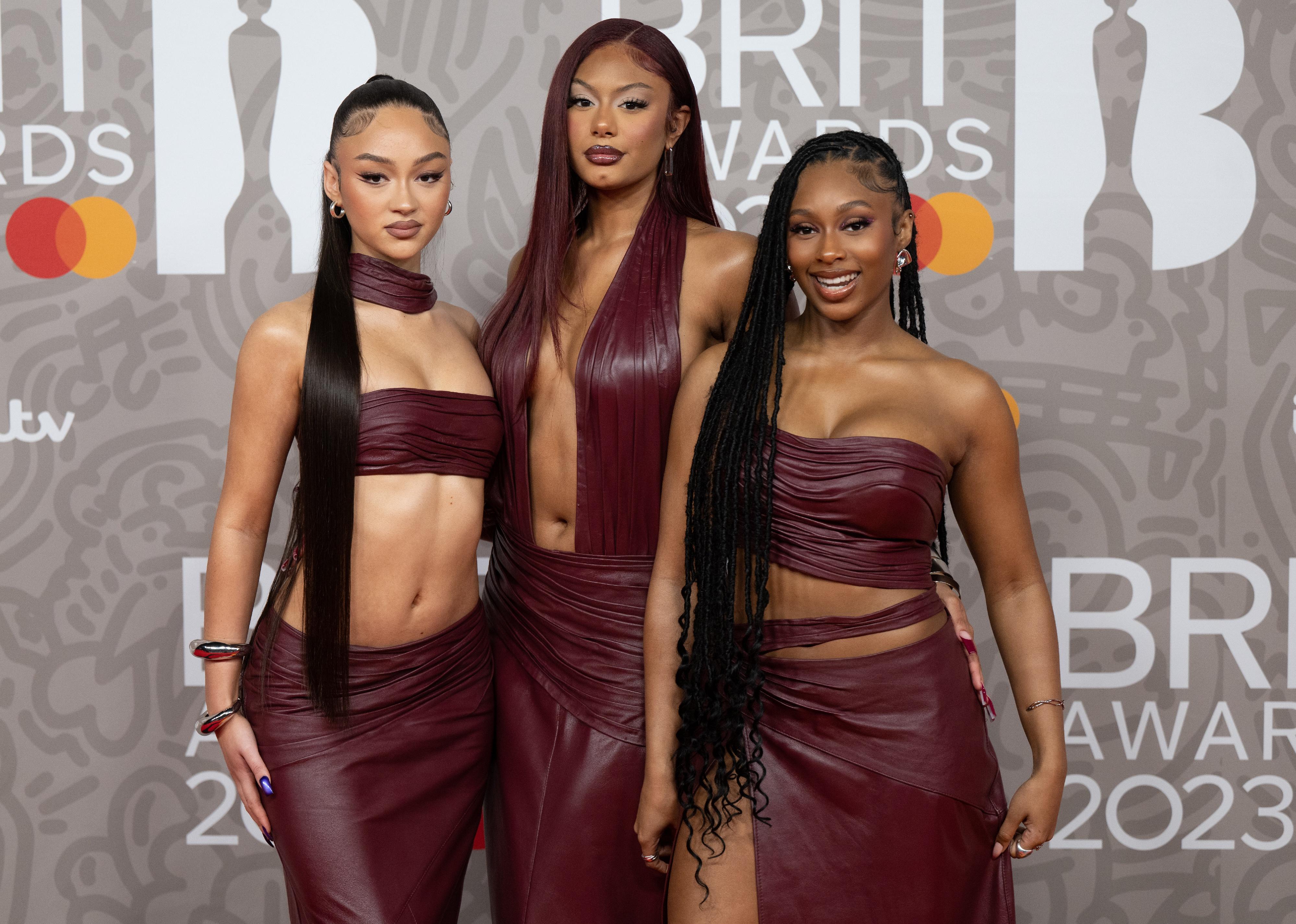 Jorja Douglas, Stella Quaresma and Renée Downer of Flo in matching burgundy leather outfits.