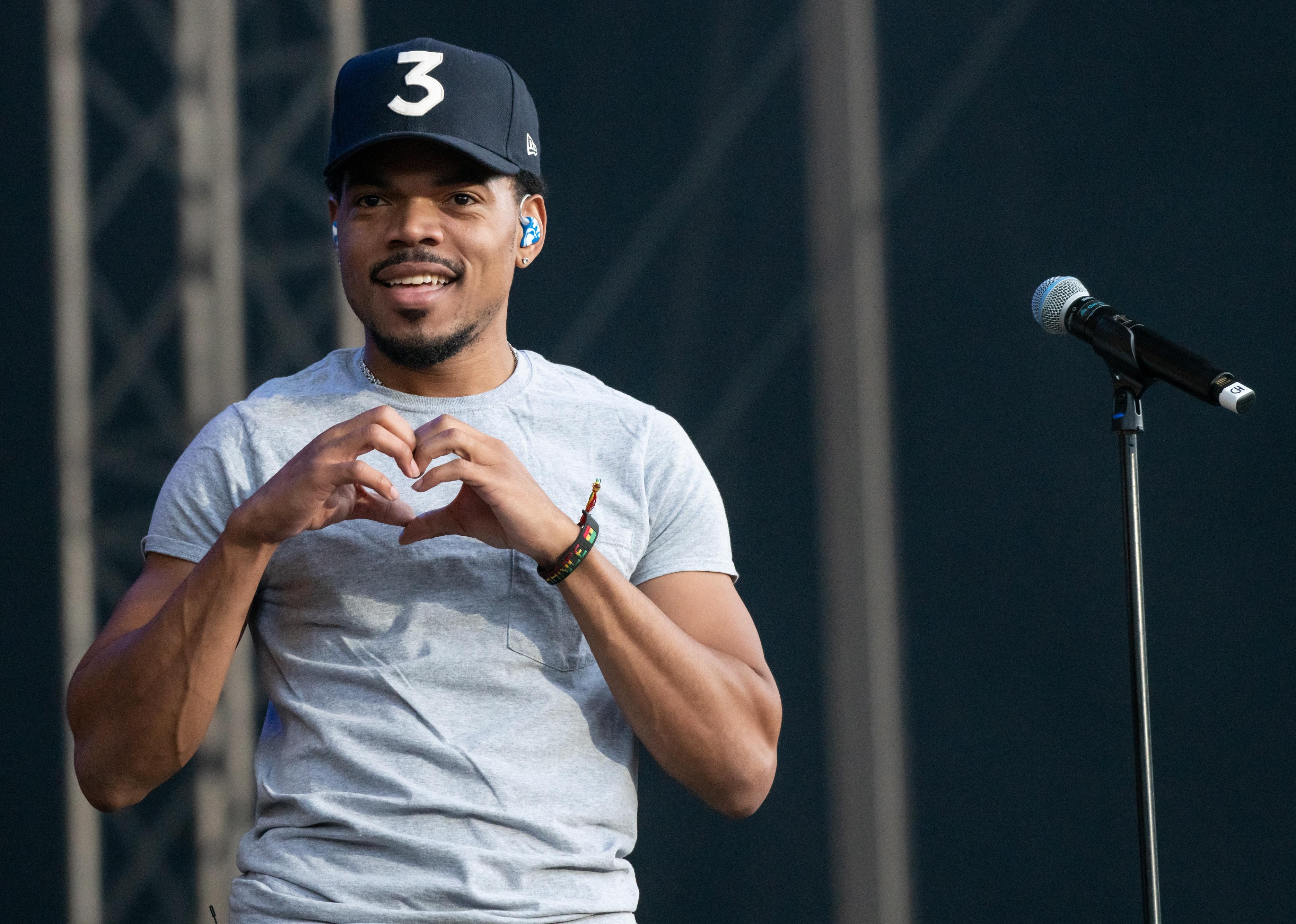 Chance The Rapper making a heart with his hands onstage.
