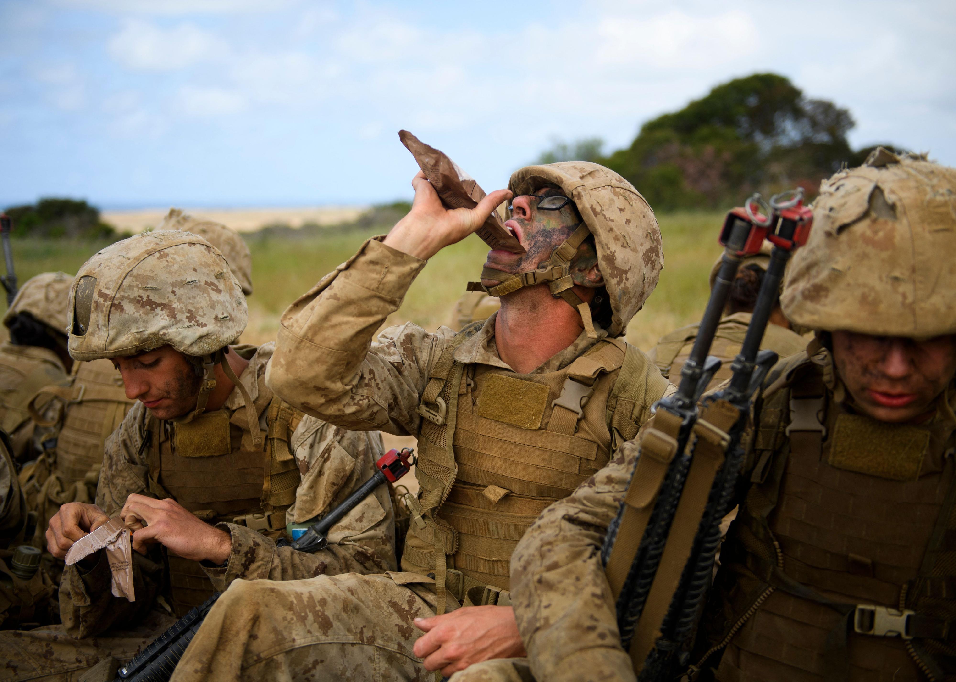 Marines eating MRE's out of the bag.