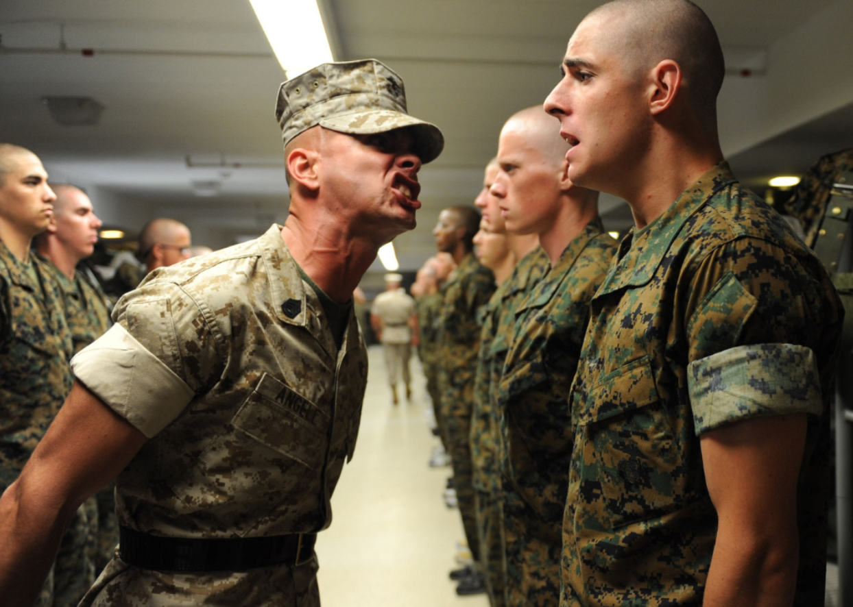 A soldier being yelled at by his superior.