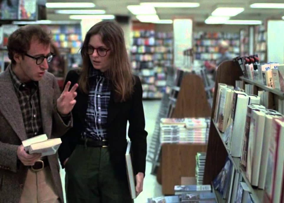 A man and woman deep in discussion in a book store.