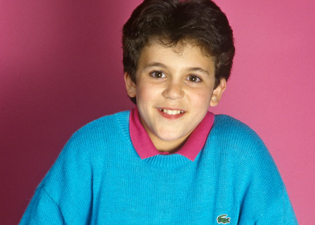 Fred Savage in a turquoise sweater.