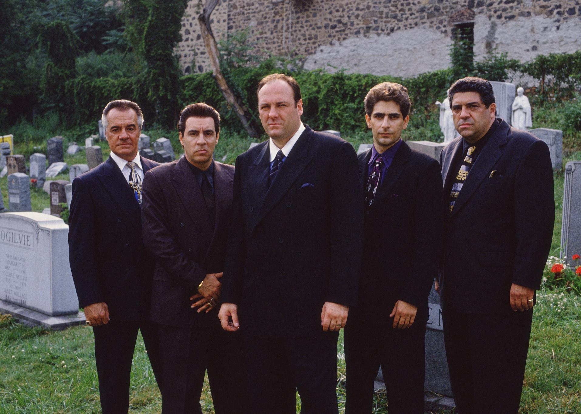 Tony Sirico, Vincent Curatola, James Gandolfini, Michael Imperioli and Silvio Dante at a cemetery.