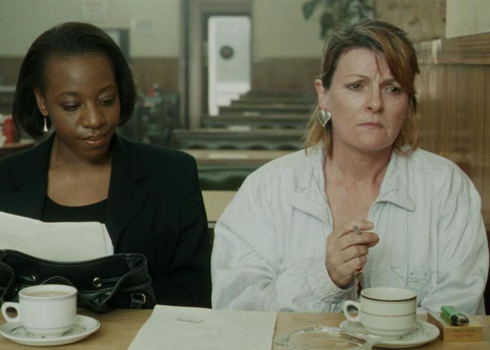 Two depressed-looking women sit at a diner.