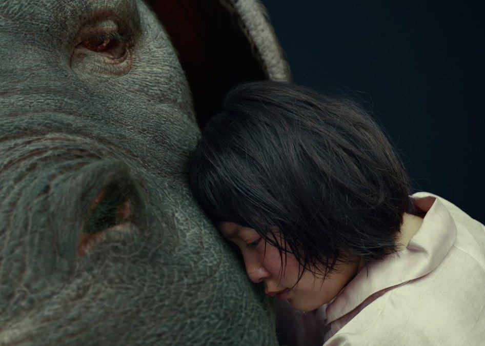 A woman hugging a giant creature.