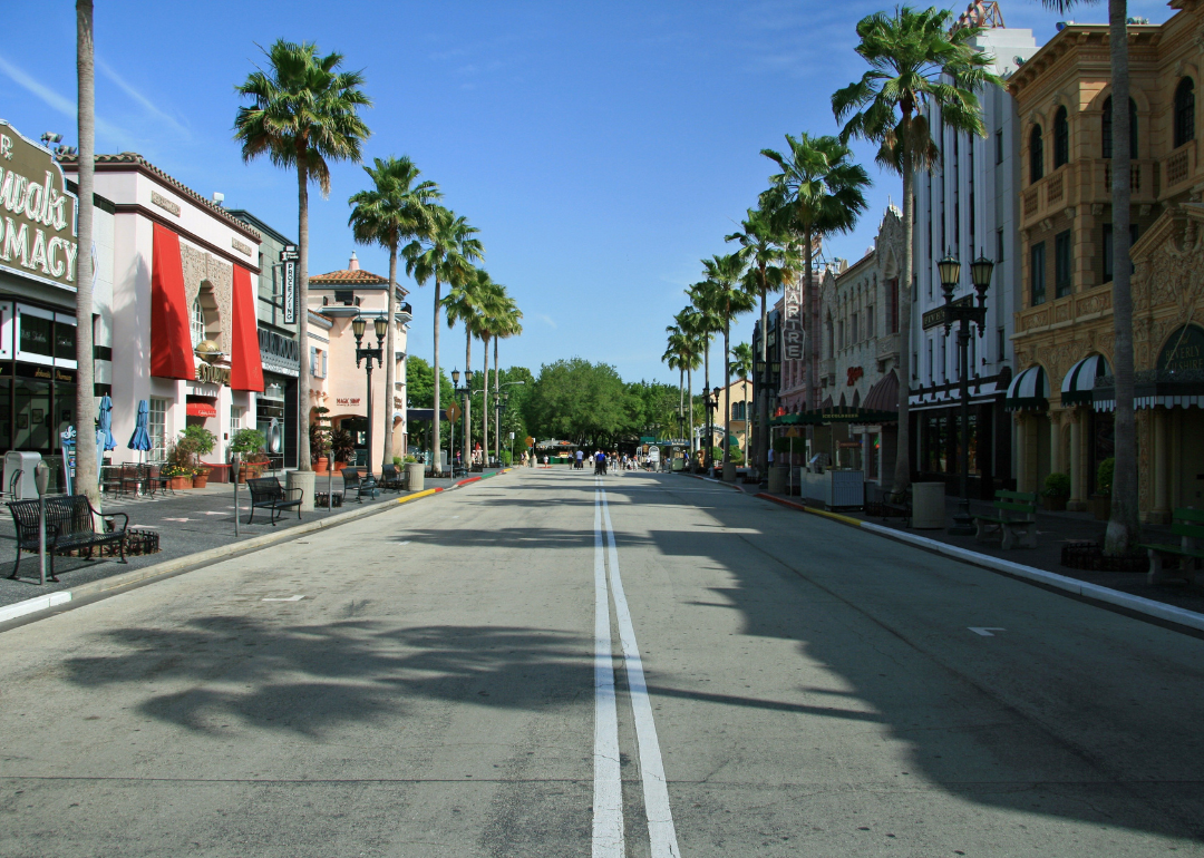 Historic buildings and palm trees lining a street.