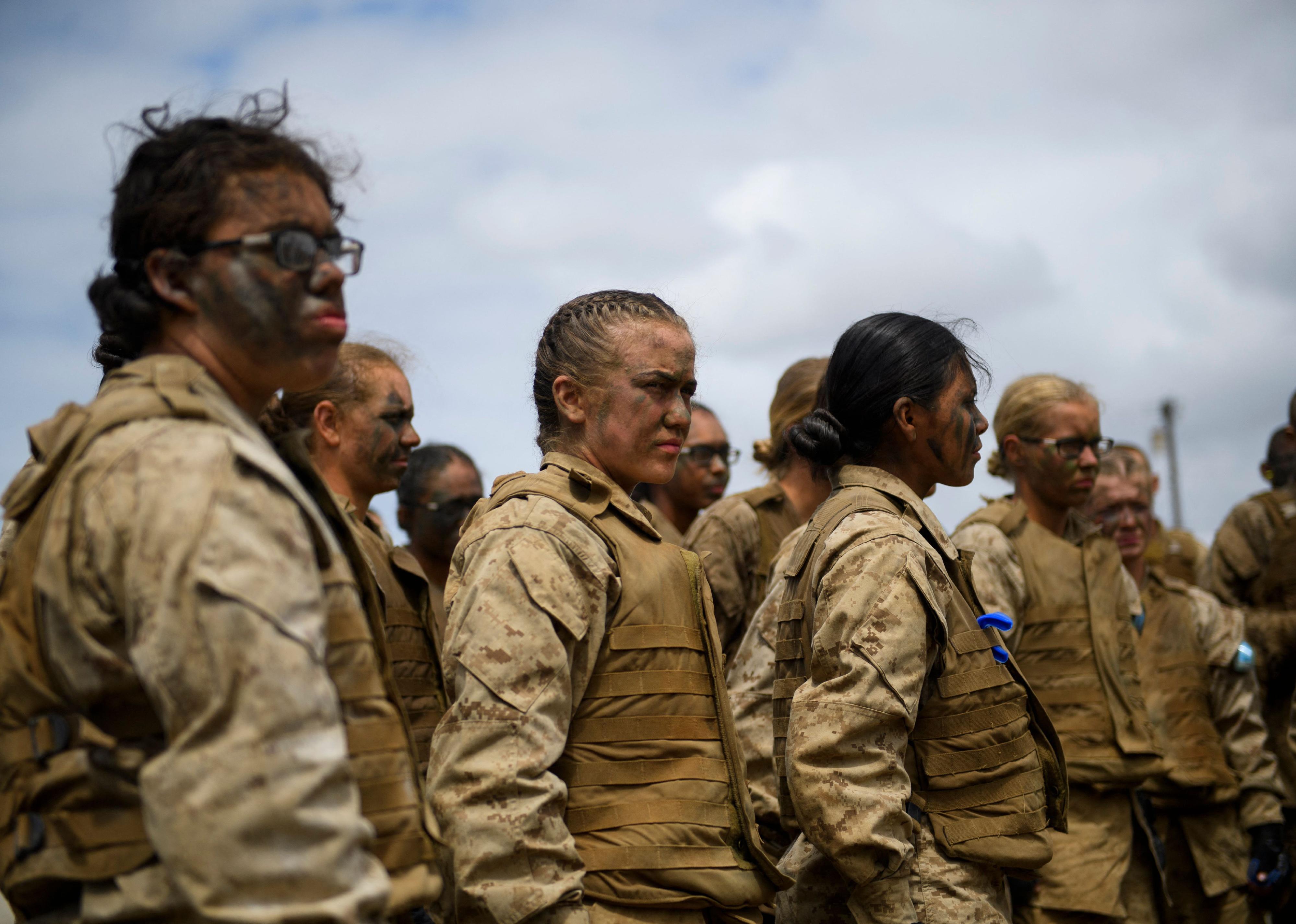 A group of women in tan camouflage military gear.