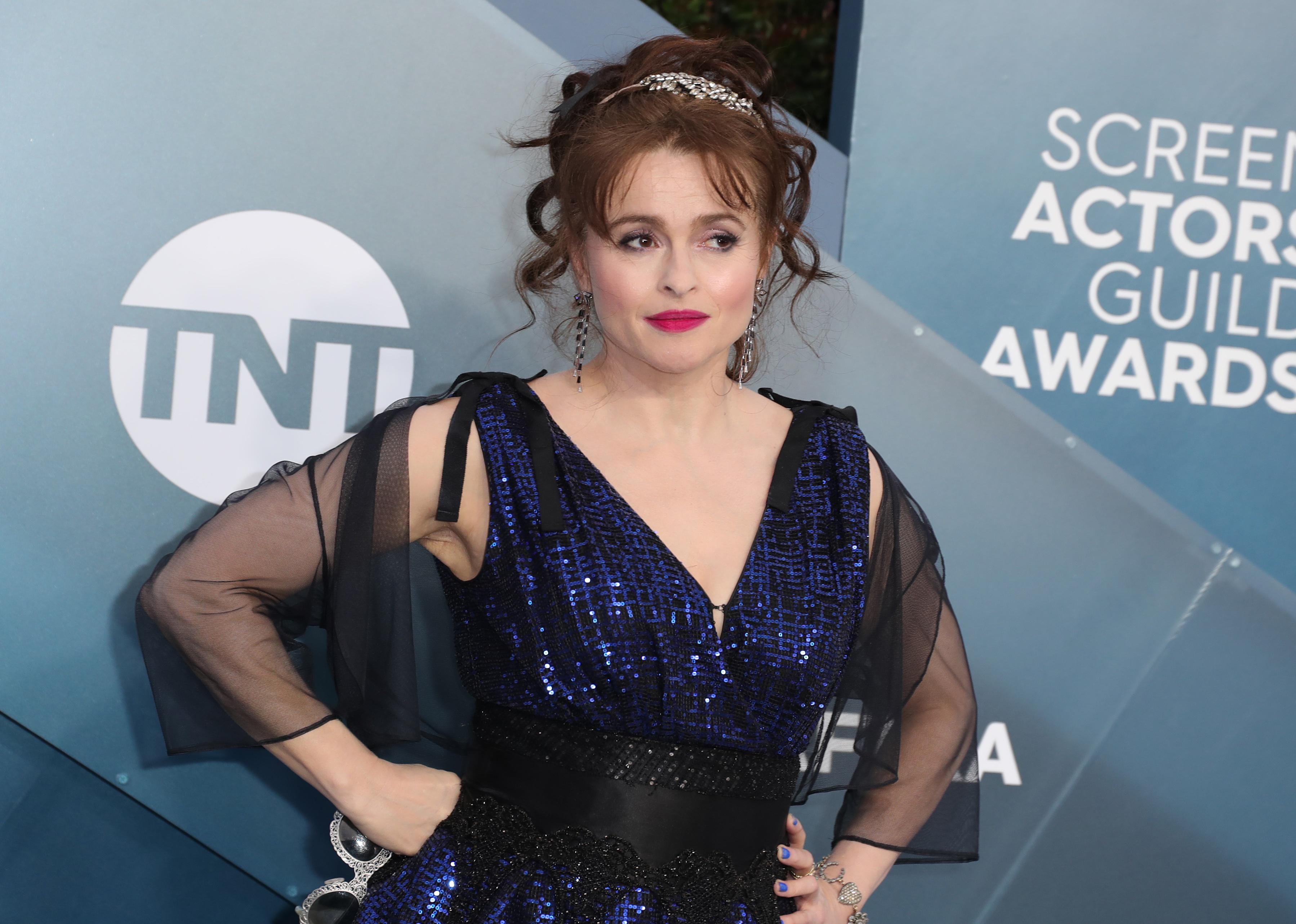 Helena Bonham Carter in a blue sequin dress with a black sheer wrap.