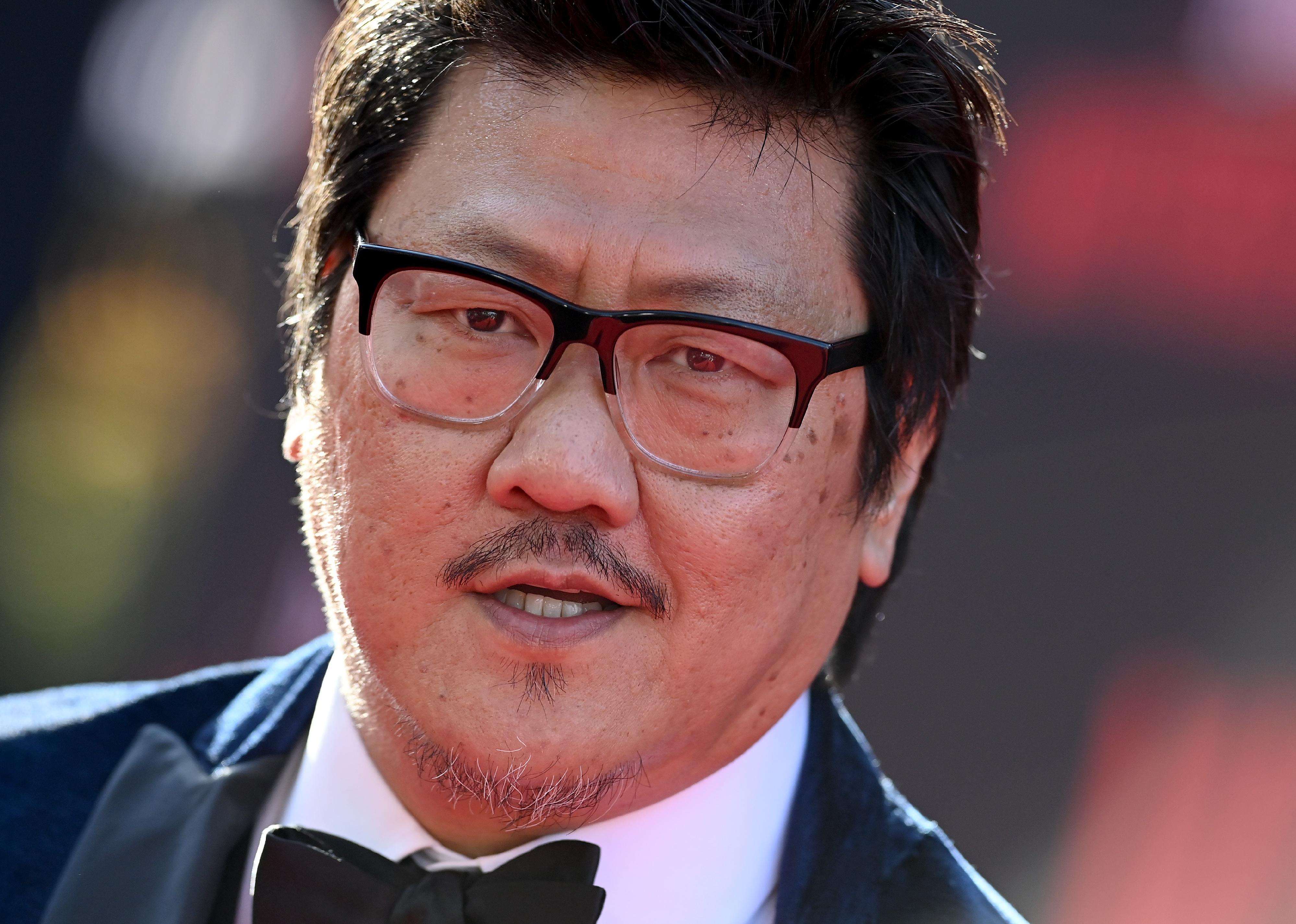 Benedict Wong in a black suit and bowtie.