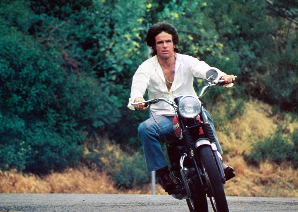 Warren Beatty rides a motorcycle in the film Shampoo in 1975.