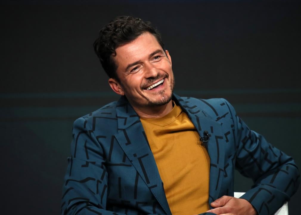 Orlando Bloom speaks onstage during a press tour in 2019.