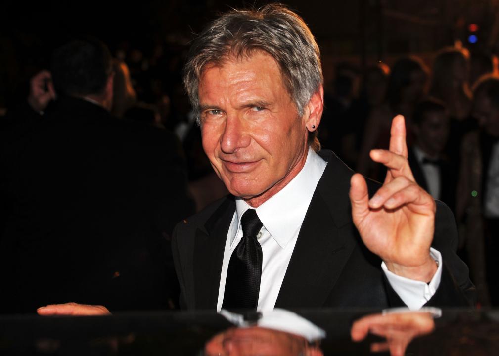 Harrison Ford waves to the camera at a film festival.