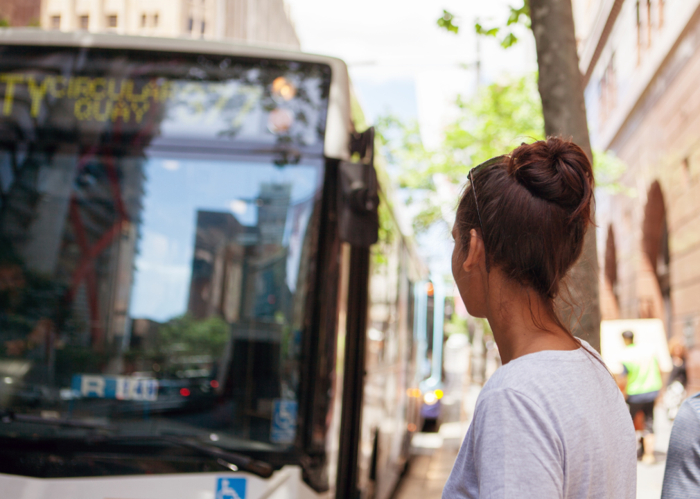 A woman waiting for a bus.