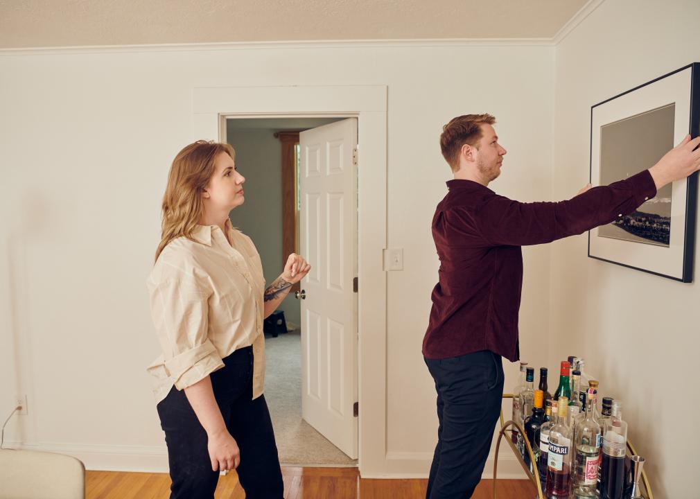 A millennial couple decorating their new home.