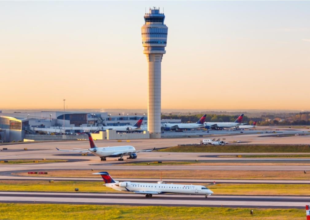 Endeavor Air jet on the runway in front of a tower.