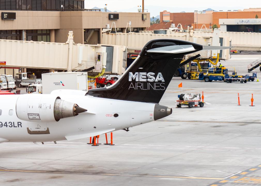 Mesa Airlines aircraft parked at a gate at Phoenix Sky Harbor International Airport.