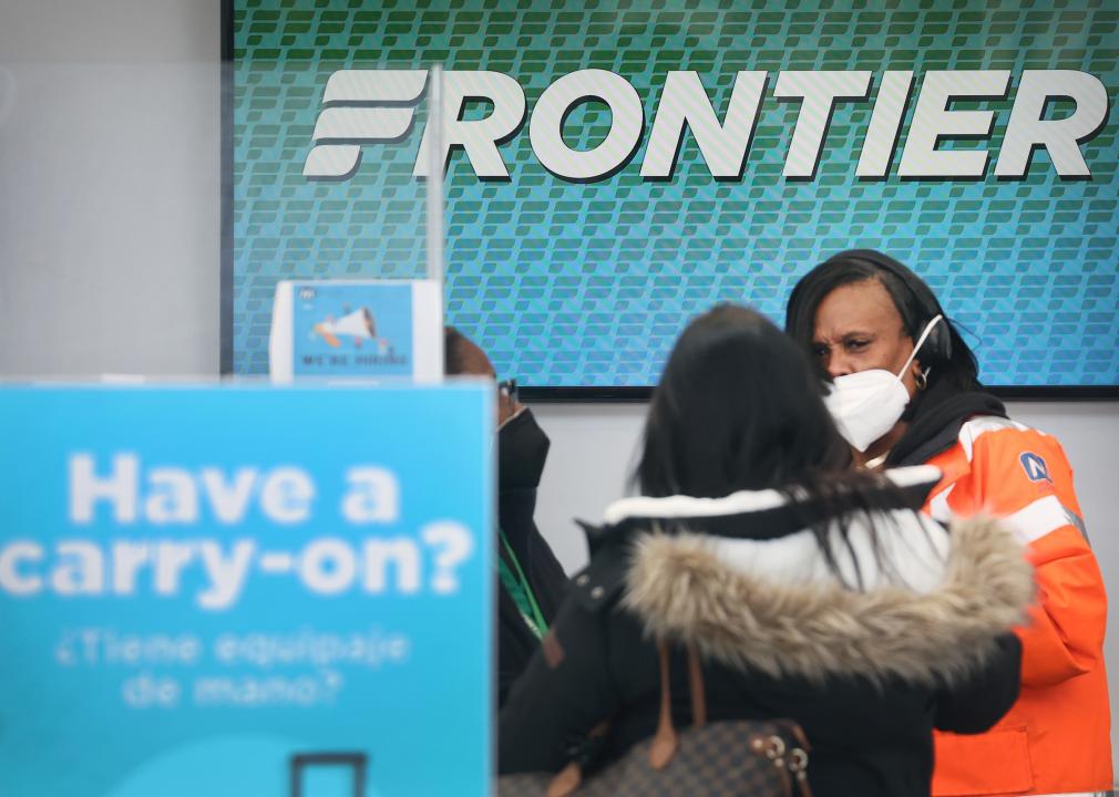 Passengers check in for flights on Frontier Airlines.