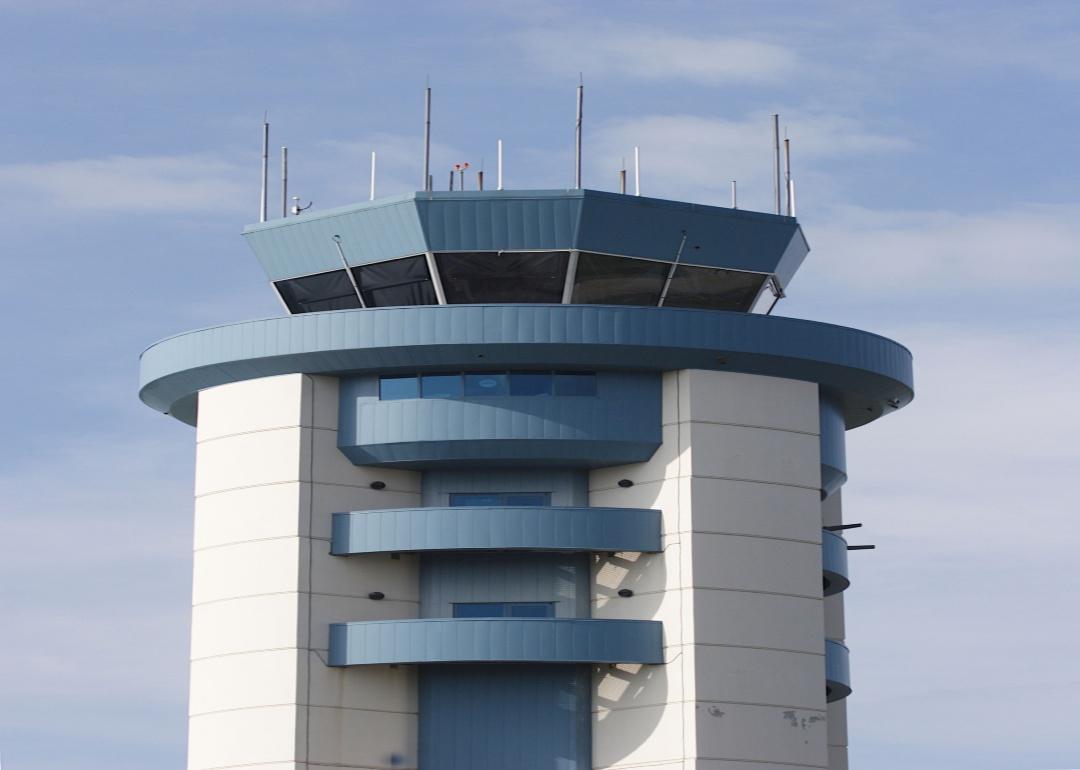 A blue and white airport control tower.
