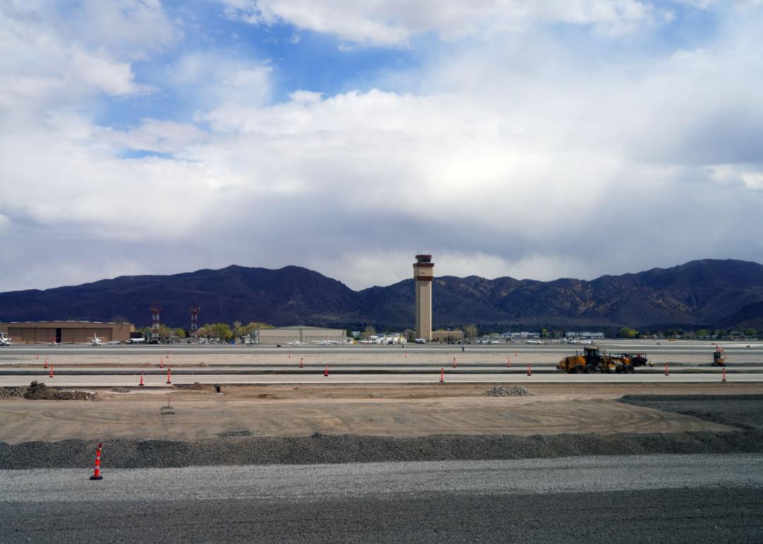The Reno-Tahoe Airport runway and tower with mountains in the background.