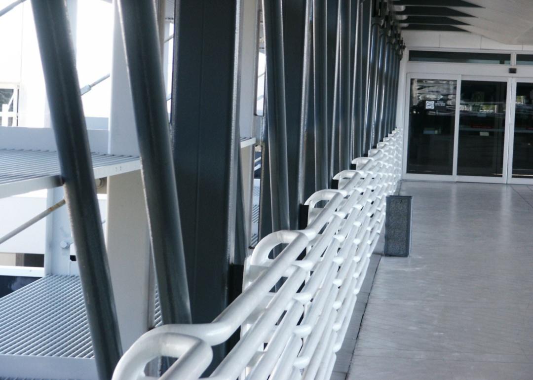 A walkway with a white chain hand rail at Pensacola Airport.