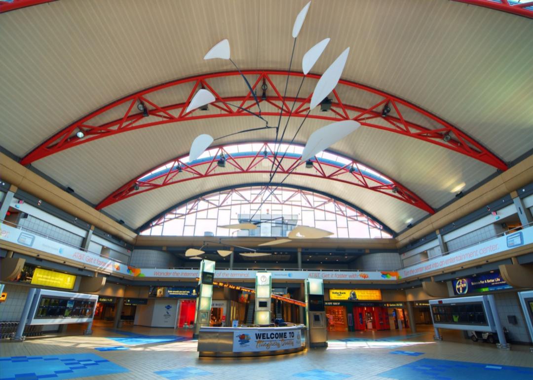 A large atrium with red arches in Pittsburgh airport.