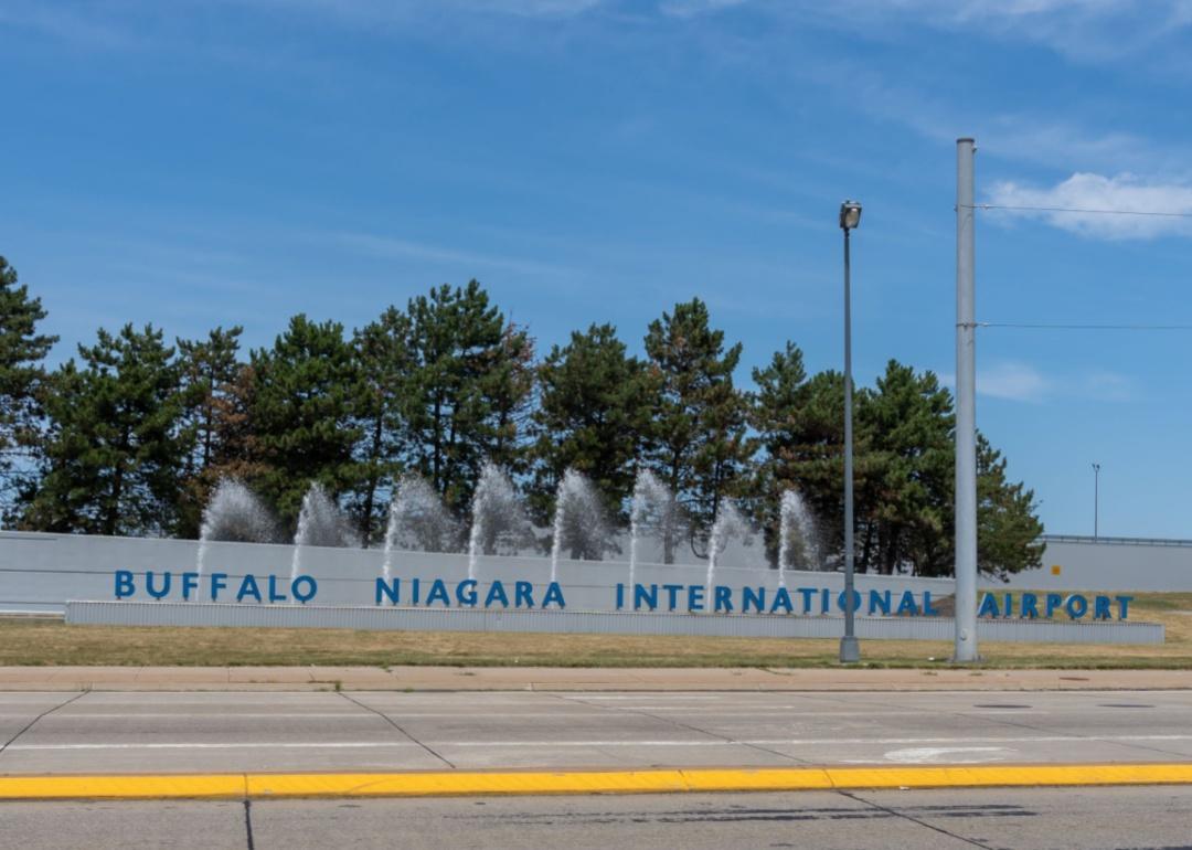 The entrance sign to Buffalo Niagara airport with a water fountain.