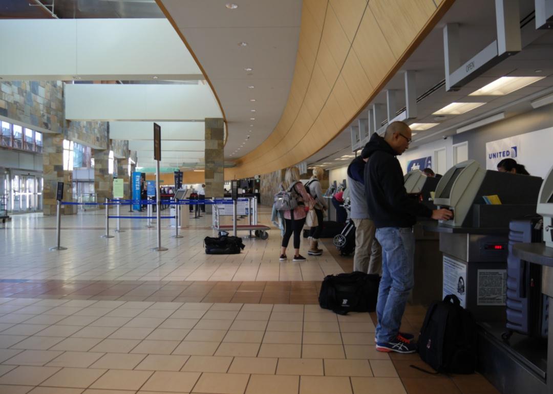 Passengers checking into kiosks at Will Rogers World airport.