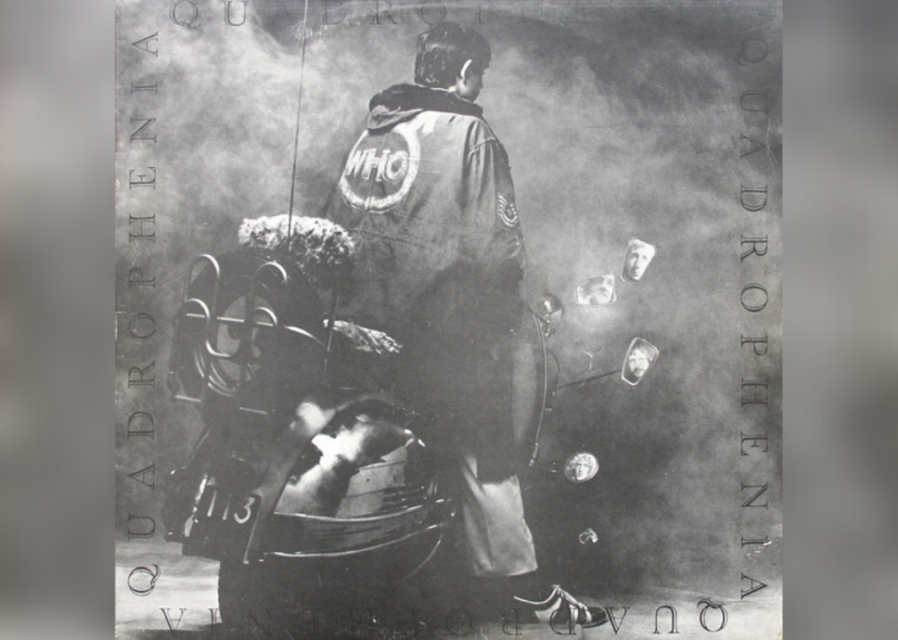 Black and white image of a man on a scooter from behind with images of band members' faces in each mirror on the bike.