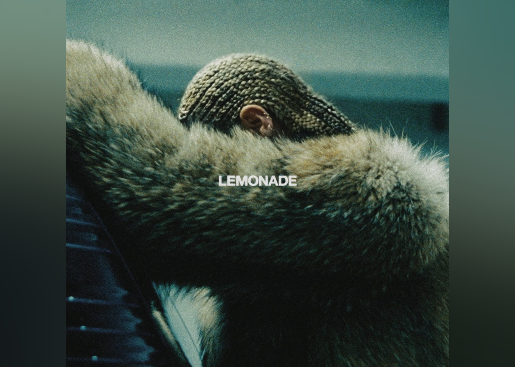 Beyonce in a fur coat looking down.