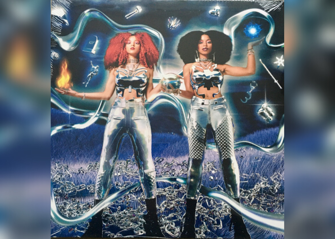 The Nova Twins in silver suits with a galactic background.