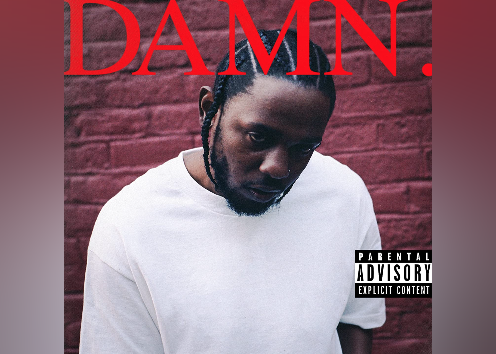 Kendrick Lamar in a white shirt with red writing on top of the album.