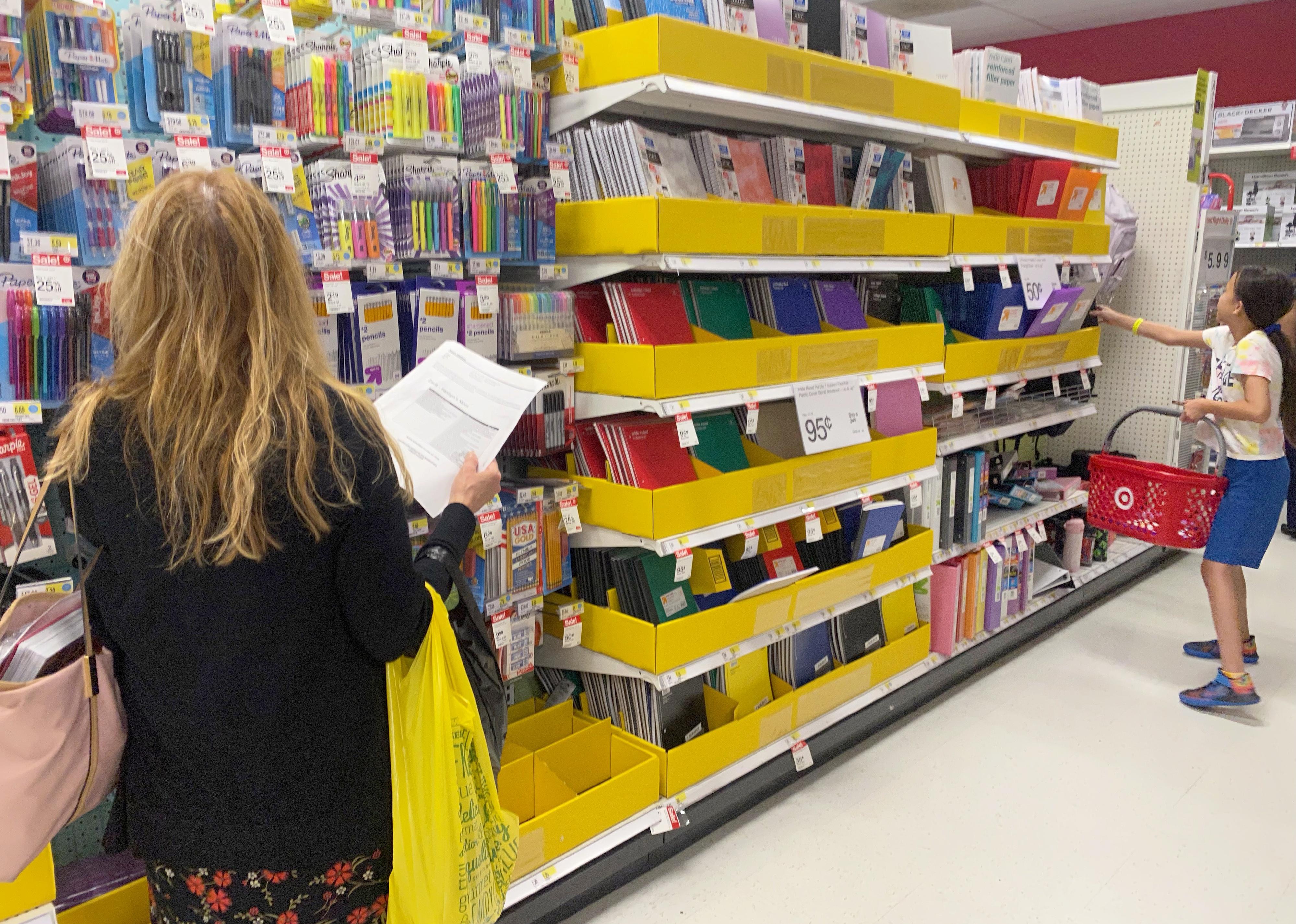 A woman and a girl shop for school supplies.