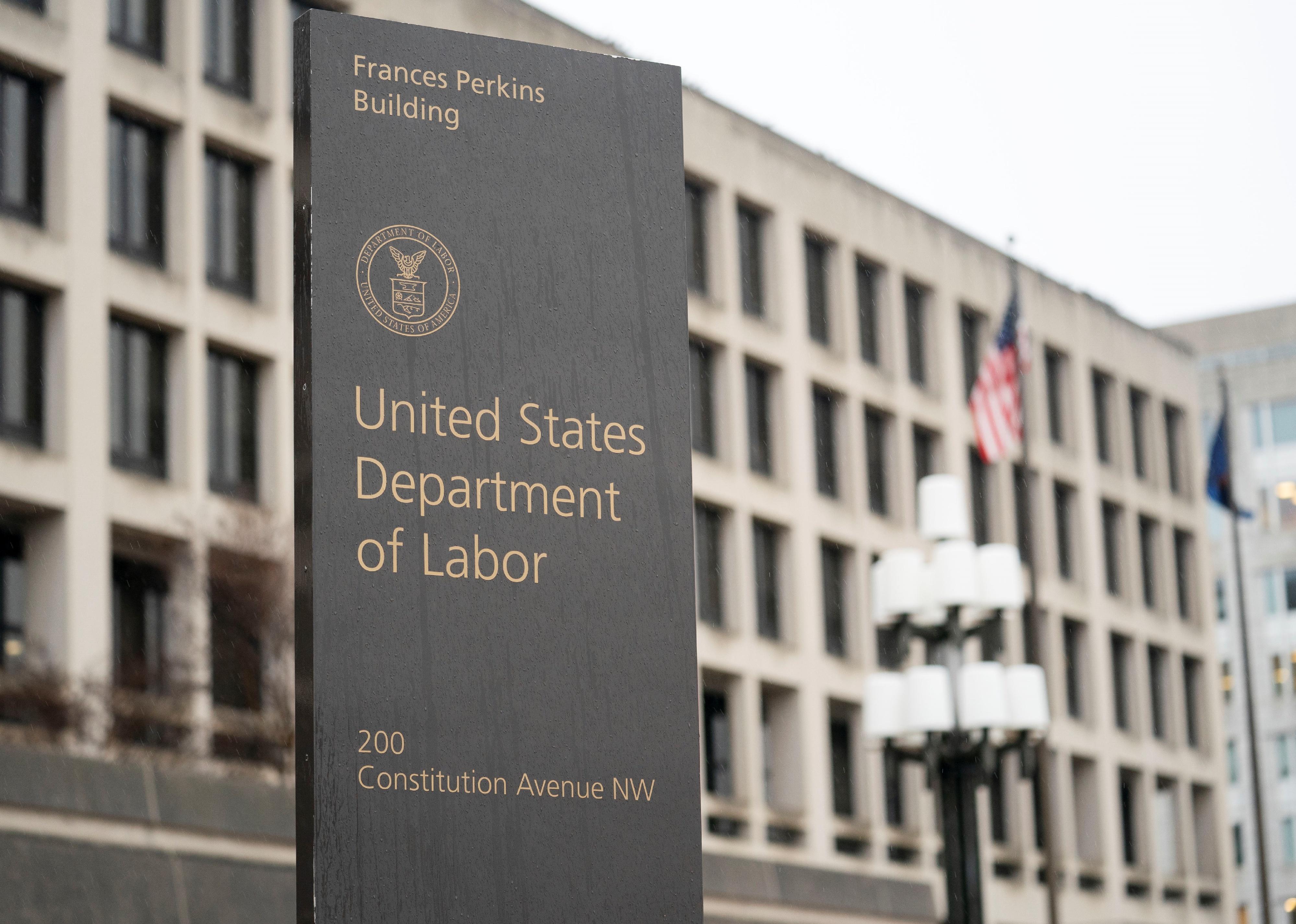 A sign in front of the Department of Labor building.