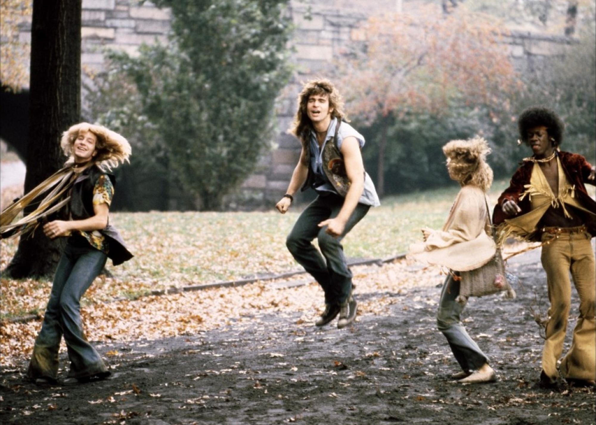 A group of hippies dancing in a park.