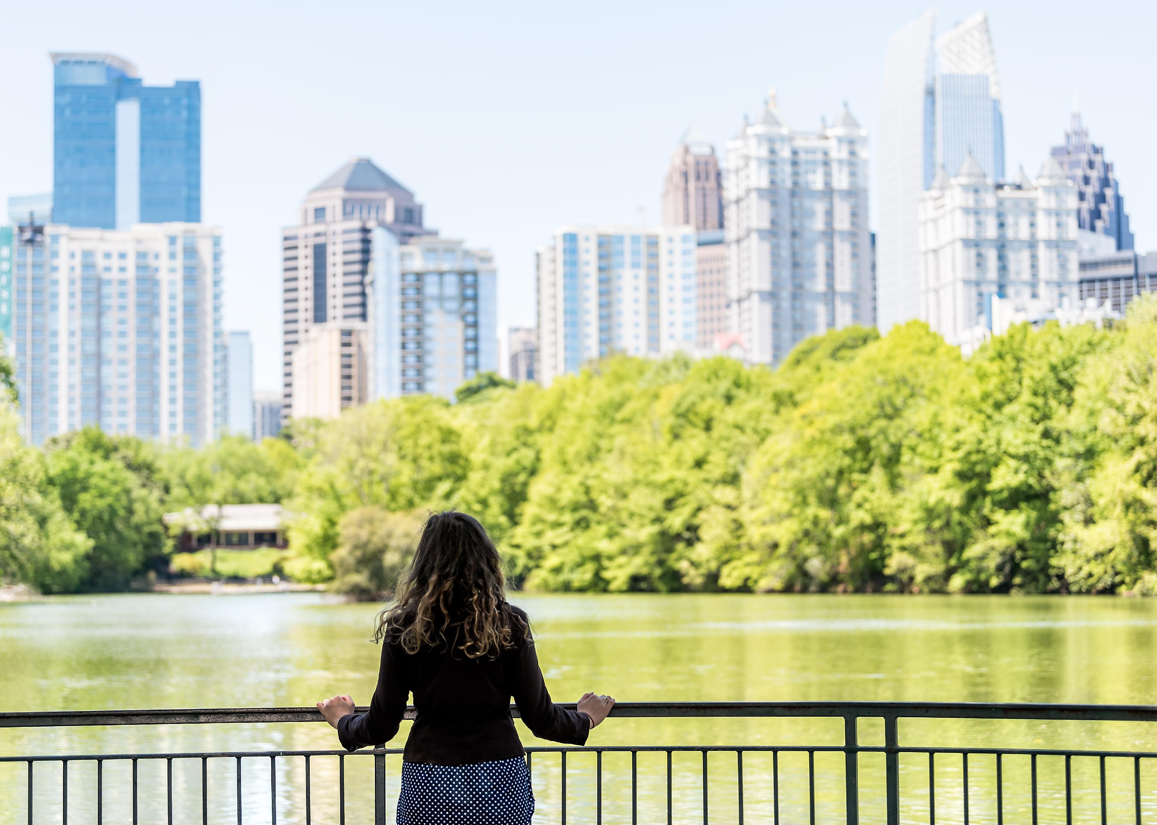 A woman looks at the Atlanta skyline.
