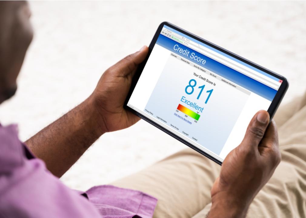 Person viewing credit score on tablet.