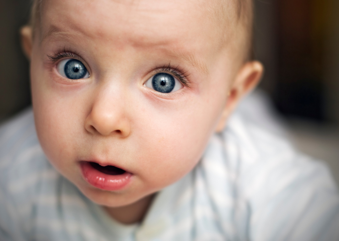 A baby boy with big blue eyes.