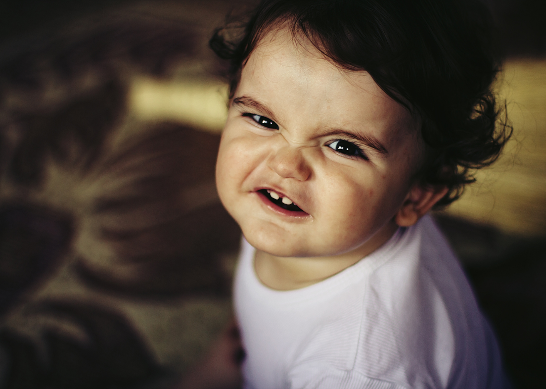 A baby boy making a funny face.