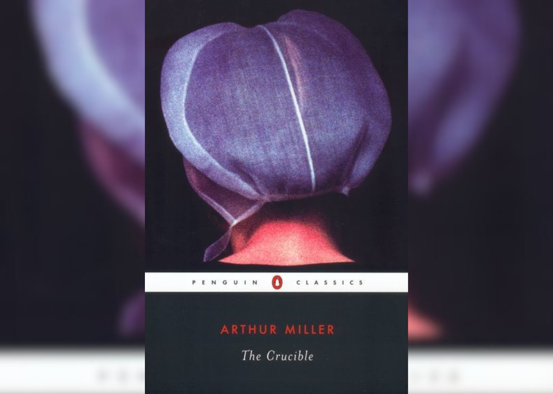 The back of a woman's head wearing a bonnet.