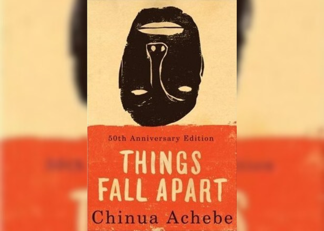 An orange background with a black upside down mask.