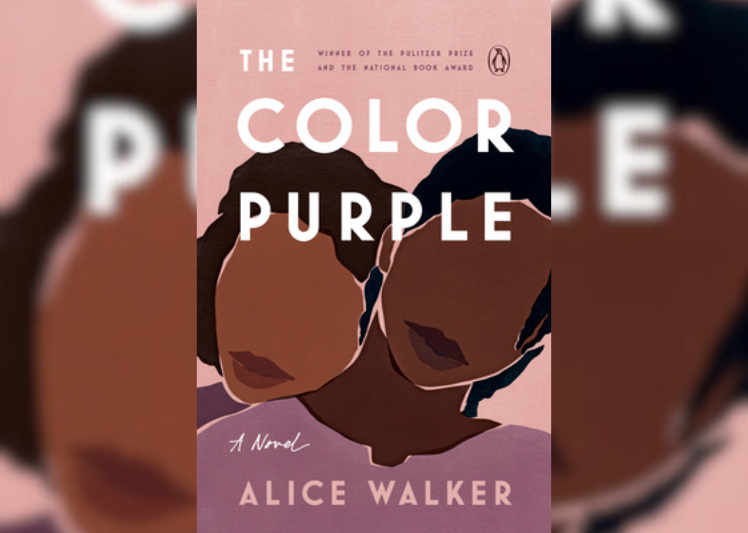 Two black women leaning on one another.